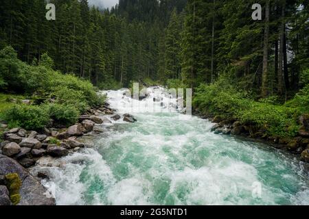 Mountain blue water river and trees landscape natural environment. Hiking in the alps. Grawa Waterfall in Stubai Valley, Tyrol, Austria Stock Photo
