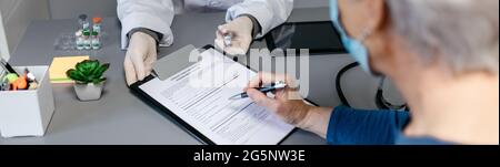 Doctor explaining to her patient the benefits and risks of the coronavirus vaccine Stock Photo