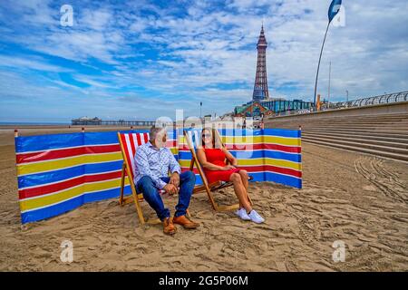 Deckchairs for hire on the Promenade at Blackpool beach, Lancashire for the first time in over ten years. Local businessman Andrew Beaumont (left) and his sister Kathryn Lee (right) has leased a section of the Promenade from the local council to set up Blackpool Deckchairs which will rent up to 500 chairs and windbreaks to tourists each day. Picture date: Tuesday June 29, 2021. Stock Photo