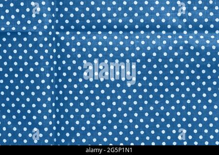 Polka dot on classic blue canvas cotton texture. Blue fabric with printed white circles. Bright colored cotton background Stock Photo