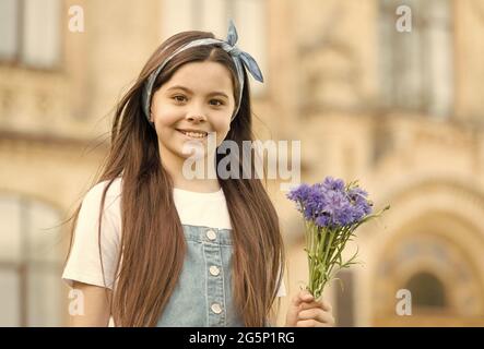 Little girl cornflowers bouquet holiday greetings, mothers day concept Stock Photo