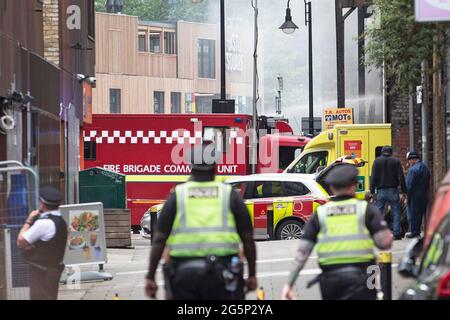 Fire fighters and Police tackle a fire near the Elephant and Castle station as a garage under the arches catches alight on the 28th of June 2021 Stock Photo