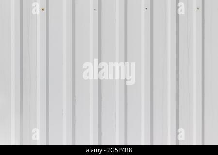 White metal wall or fence background with vertical corrugated stripes Stock Photo