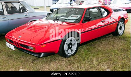 Three-quarters front view of a Red, 1980, BMW M1, on display at the 2021, London Classic Car Show, Syon Park Stock Photo