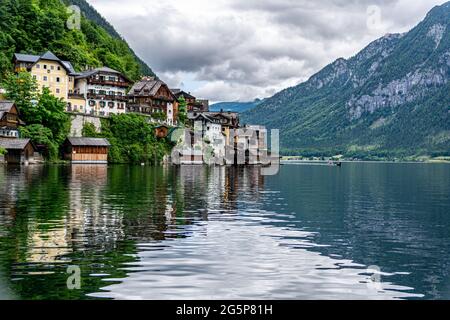 View of traditional houses in Hallstatt, Austria. Reflections in the Lake on a summer day with overcast Stock Photo