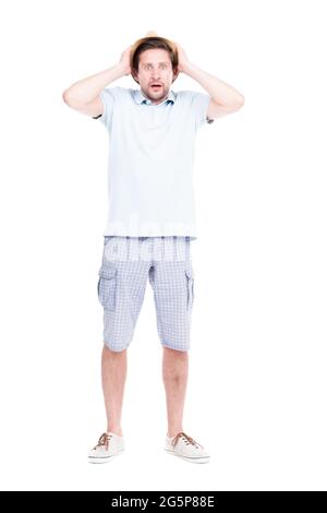 Vertical full length studio portrait of handsome bearded Caucasian man wearing summer outfit amused because of something, white background Stock Photo