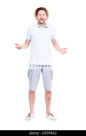 Vertical full length studio portrait of handsome bearded Caucasian man wearing summer outfit amused because of something, white background Stock Photo
