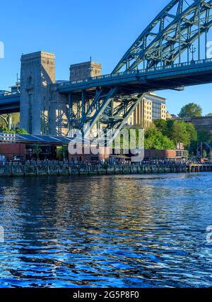The Gateshead side of the River Tyne. In the shadow of the enormous Tyne Bridge. The area beneath is Träkol a riverside restaurant and bar.
