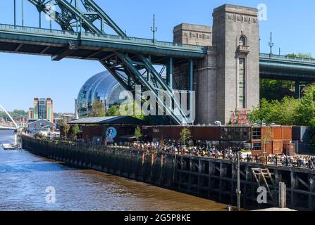 The Gateshead side of the River Tyne. In the shadow of the enormous Tyne Bridge. The area beneath is Träkol a riverside restaurant and bar.