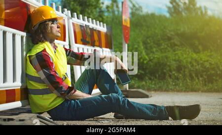 Tired male worker using smartphone on a break. Stock Photo