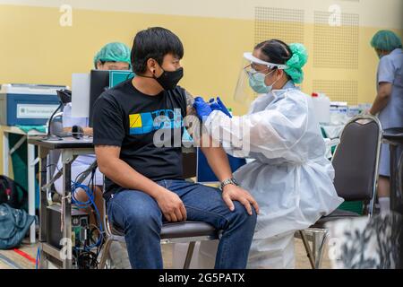 Chiang Mai, Thailand - 28 June 2021 - A Thai man get his COVID-19 vaccine in Chiang Mai, Thailand Stock Photo