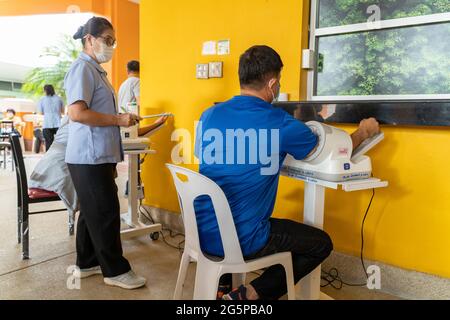 Chiang Mai, Thailand - 28 June 2021 - People get their blood pressure check before getting the COVID-19 vaccine in Chiang Mai, Thailand Stock Photo