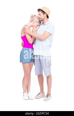 Vertical full length studio portrait of modern young adult man comforting his sad girlfriend, white background Stock Photo