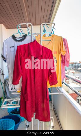 wwet laundry is hung up to dry on the balcony Stock Photo