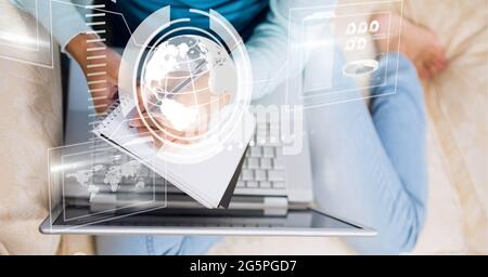 Composition of screen with digital data processing over woman writing using laptop Stock Photo