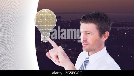 Composition of businessman touching interactive screen with lightbulb Stock Photo