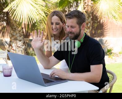 Close up of young couple using laptop at home. Stock Photo