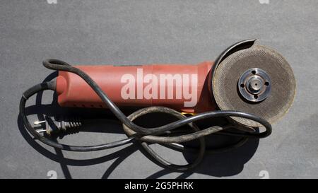 A Close Up of an Angle Grinder on a Black Background Stock Photo