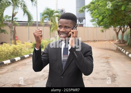 Image of handsome african businessman talking on cell phone Stock Photo