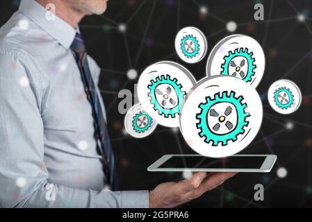 Business process concept above a tablet held by a man Stock Photo