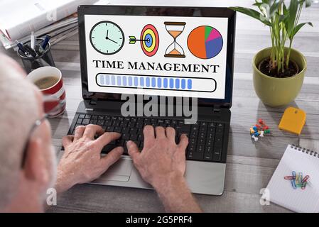 Time management concept shown on a laptop used by a man Stock Photo