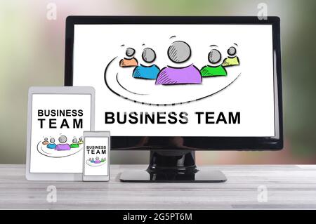 Business team concept shown on different information technology devices Stock Photo