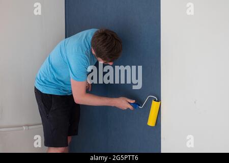 Tool, roller for smoothing wallpaper. Wallpapering in the apartment. Stock Photo