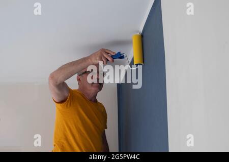 Tool, roller for smoothing wallpaper. Wallpapering in the apartment. Stock Photo