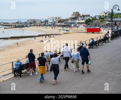 Lyme Regis, Dorset, UK. 29th June, 2021. UK Weather. People were out and about enjoying the warm, but humid conditions at the seaside resort of Lyme Regis this afternoon but the forecast of heavy rain seemed to have kept many visitors away. Credit: Celia McMahon/Alamy Live News