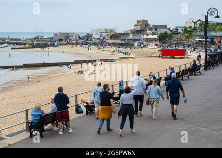 Lyme Regis, Dorset, UK. 29th June, 2021. UK Weather. People were out and about enjoying the warm, but humid conditions at the seaside resort of Lyme Regis this afternoon but the forecast of heavy rain seemed to have kept many visitors away. Credit: Celia McMahon/Alamy Live News