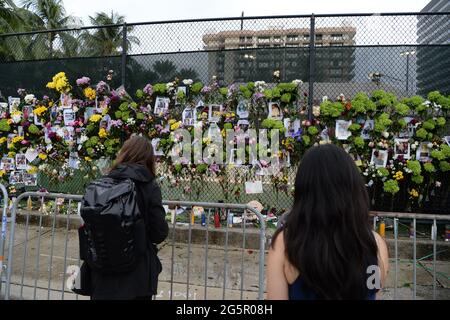 SURFSIDE FL - JUNE 28: people gather at the site of the make shift memorial, after the Champlain Towers south 8855 Collins Avenue which had collapsed, as family members remain missing after the collapsed condo building in Surfside on June 28, 2021 in Miami, Florida. :  Credit: mpi04 / MediaPunch Stock Photo