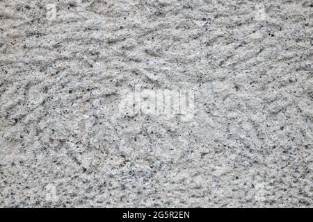 Rough grey limestone wall, neutral background with coarse texture and black pores, mineral backdrop inspiration and stone wall ideas, architecture Stock Photo