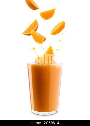 Glass of orange juice with splashing orange slices, on white background Stock Photo