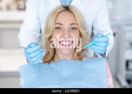 Portrait of smiling female patient attending dental clinic Stock Photo