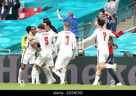 England's Raheem Sterling (left) celebrates scoring their side's first goal of the game during the UEFA Euro 2020 round of 16 match at Wembley Stadium, London. Picture date: Tuesday June 29, 2021. Stock Photo