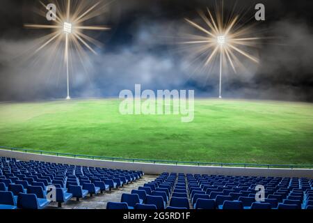 Empty football stadium field at night. Stock Photo