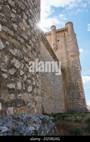 Vertical shot of a backlight in a castle. Sunbeams on the castle of Torrelobaton built in the 13th century. Stock Photo