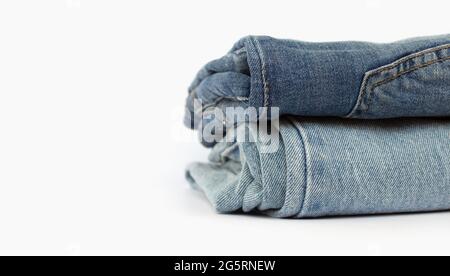 stack of blue jeans isolated on white background, space for text, close-up Stock Photo