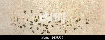 Various seeds on a marble background. Assortment, seeds set, healthy food ingredients, superfoods, copy space. Sunflower, flax, pumpkin, cannabis Stock Photo