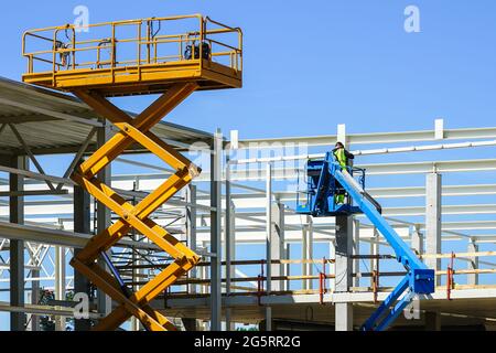 modern mobile self propelled hydraulic lifting platform and scissor lift in action Stock Photo