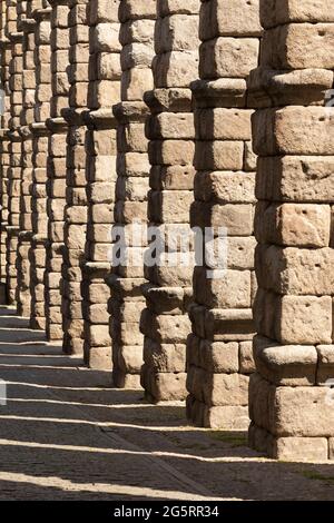 Detail of the huge granite columns of the Aqueduct of Segovia, from the upper area of Teodosio el Grande street Stock Photo