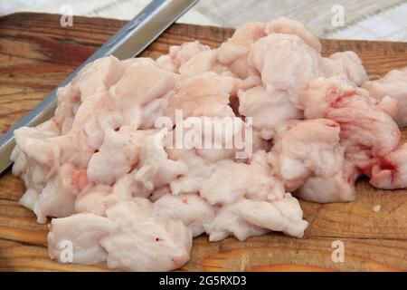 Pieces of raw lamb fat dumba are fried in a black cauldron, cooking food  Stock Photo - Alamy