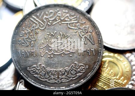 obverse side of Egyptian one pound coin, 1 LE silver coin year 1976 AD, 1396 AH with a Commemoration slogan of Saudi King Faisal bin Abdulaziz on back Stock Photo