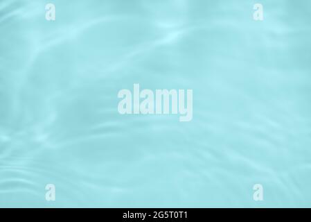Surface of light blue transparent swimming pool water. Texture of transparent blue water in swimming pool. Trendy abstract nature background. Water Stock Photo