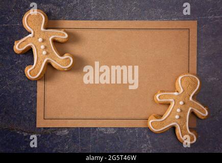 A Blank Recipe Card with Decorated Gingerbread Men on a Dark Counter Stock Photo