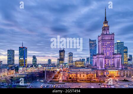 Warsaw, Poland - January 22, 2020: High angle panoramic view of Warszawa cityscape skyline with centralna train station and palace of culture night ev Stock Photo