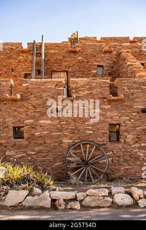 Old Wagon Wheel Leans Against The Hopi House Wall In Grand Canyon Village in the National Park Stock Photo