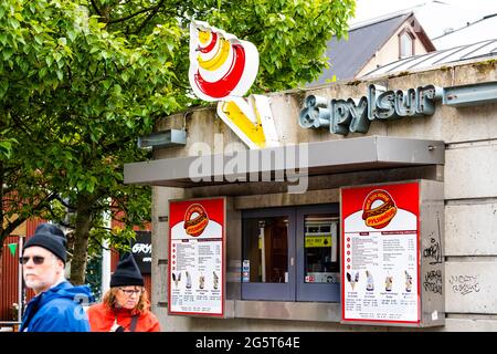 Reykjavik, Iceland - June 19, 2018: Road street square in center of downtown city with people walking by hot dog pylsuhusid pylsur house stand restaur Stock Photo