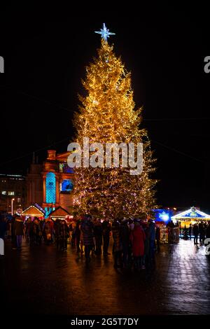 Lviv, Ukraine - December 28, 2019: Historic Ukrainian Lvov city in old town street with people by Christmas tree on Svobody Avenue vertical view Stock Photo