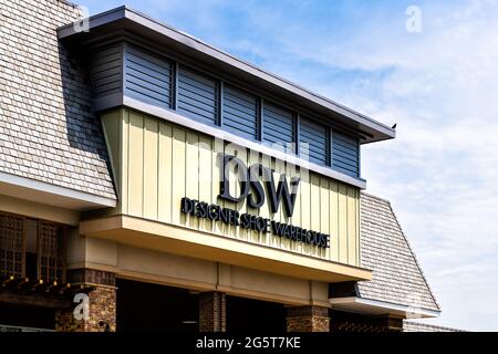 Charlottesville, USA - April 29, 2021: Virginia college city with sign for DSW shoe store outlet exterior facade and nobody Stock Photo